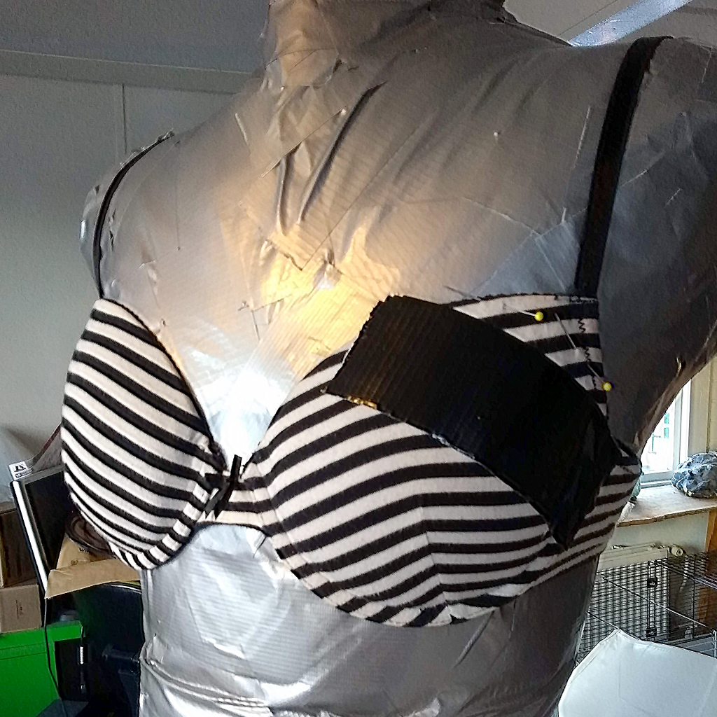 Place duct tape on the bra to make a mould.